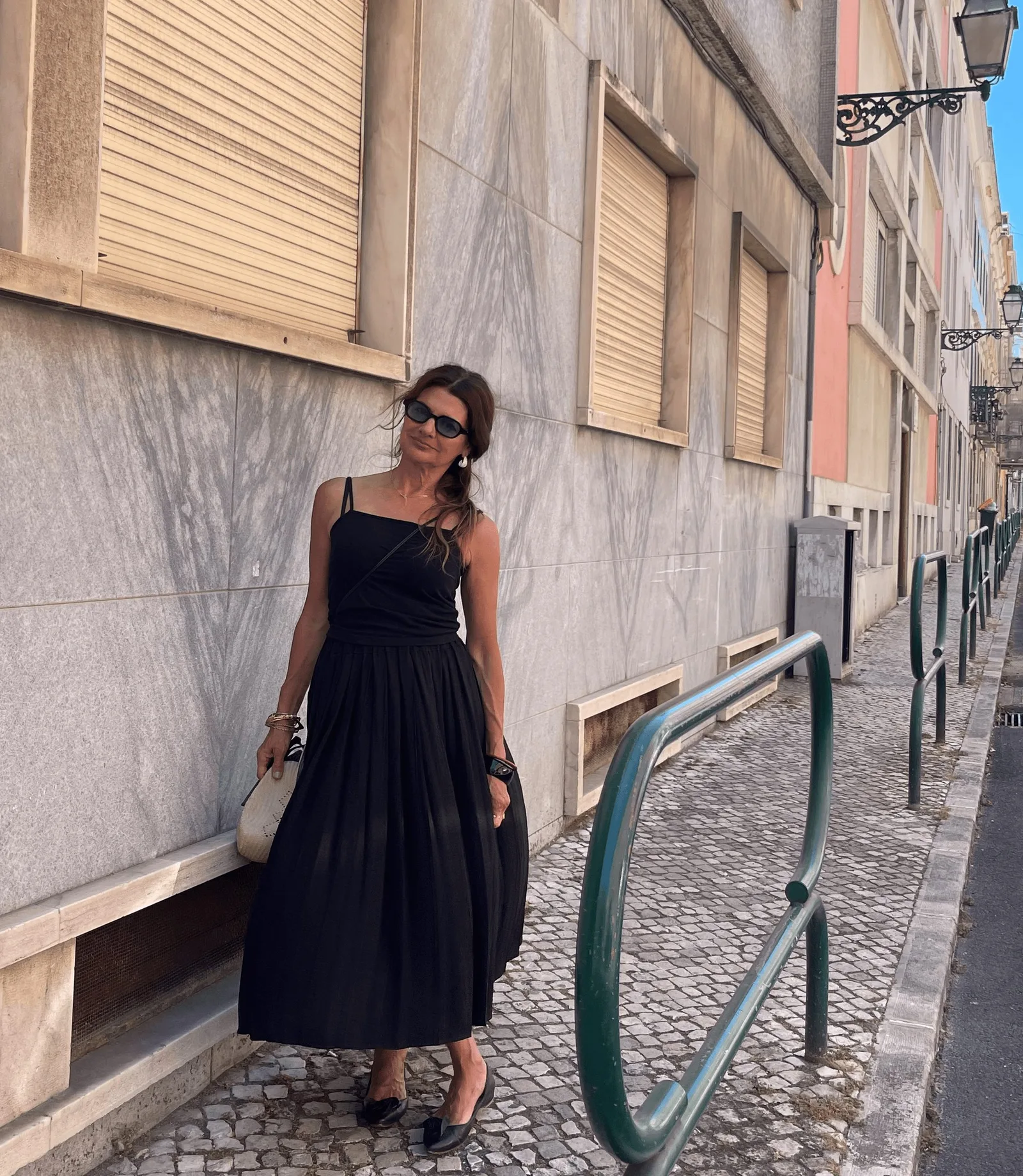 Carla Manuel on a Lisbon street in a black Kites dress
