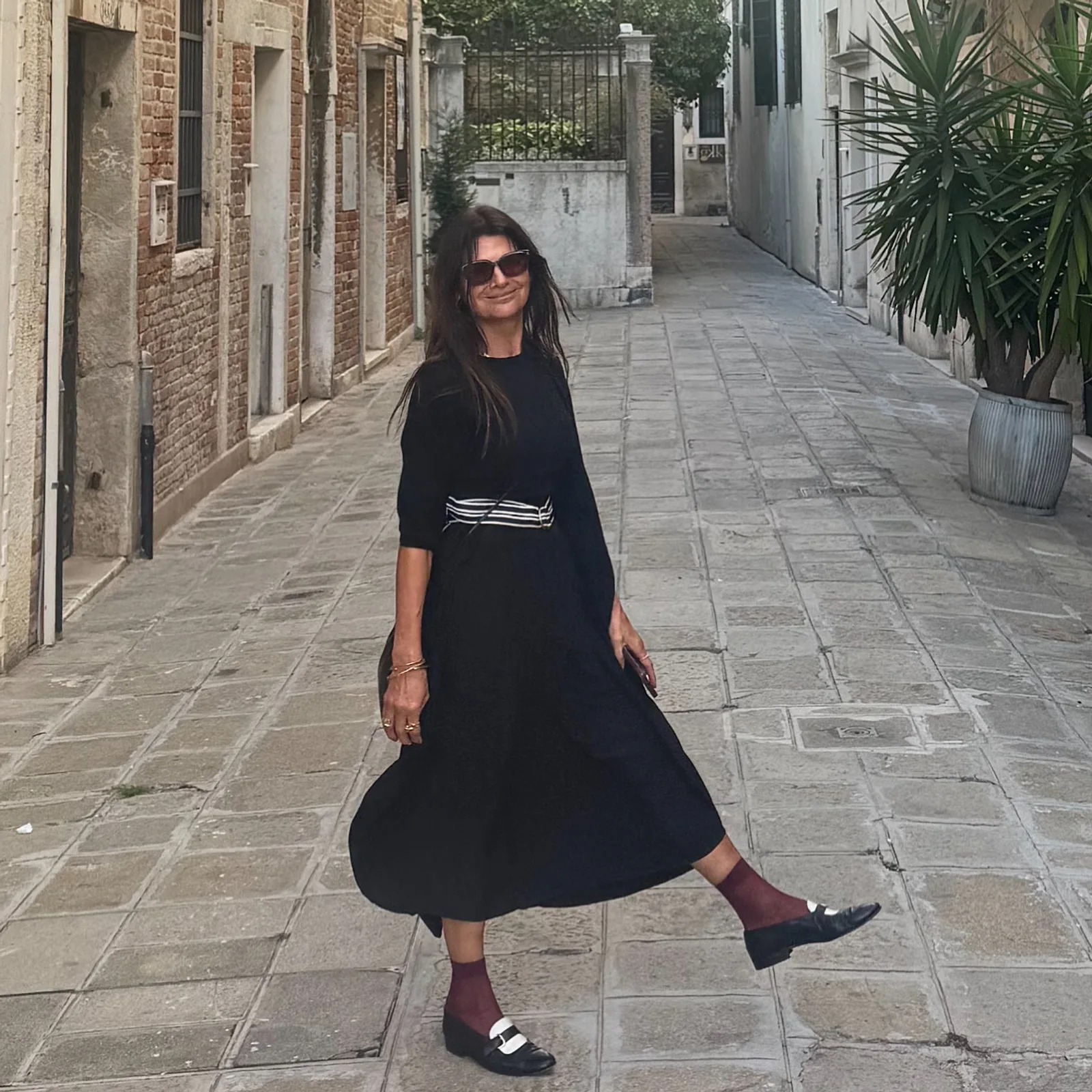 Carla Manuel in a black Kites dress on a Lisbon street, SD Voyager 2026