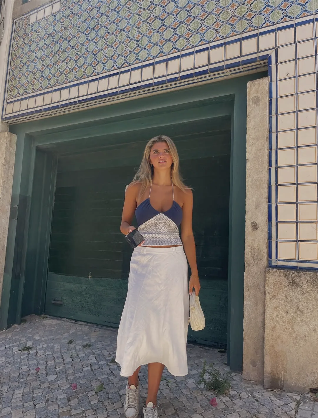 White skirt and blue top in a tiled Lisbon doorway